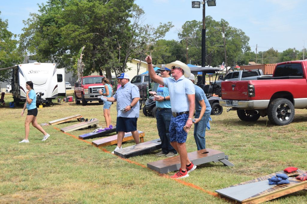 cornhole tournament men with truck